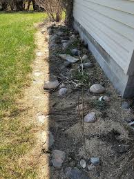 Flowers mixed in with larger rocks is a beautiful (and easy) combination. Rock Flower Bed Design For The Front Yard Della Reside