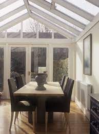 We imagine sitting with friends, glass of wine in hand, lovely food, easy conversation and a romantic view of the garden with it's strategically placed lights highlighting favourite plants and trees. Modern Conservatory Dining Room Conservatory Dining Room Home Farmhouse Dining Room