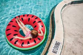 Best inner tube float review 2021 few summer activities are as fun or relaxing as floating down a lazy river in the perfect inner tube. Girl In A Swimming Pool Floating On A Watermelon Inner Tube Stock Photo Offset