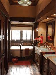The dual vanities are surfaced in a light marble, offering contrast in the space. Rustic Bathroom Decor Ideas Pictures Tips From Hgtv Hgtv