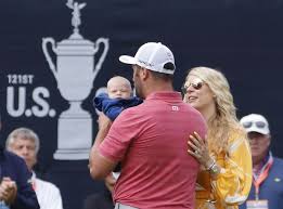 Jon rahm holding the trophy as he poses with his wife kelley cahill and son kepa cahill rahm after winning he u.s. Uhi Wxntxwm6am
