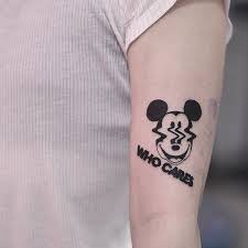 Distorted Mickey Mouse Face And Words Who Cares Inked On The Left Arm Mickey Tattoo Tattoos Mouse Tattoos