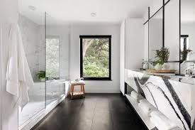 We used black marble flooring to create contrast and depth which really made the arabescato marble walls pop! Black And White Master Bath With Long Marble Walk In Shower Modern Bathroom