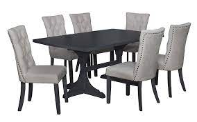 A rug centered beneath the table, a centerpiece on top of the table, and perhaps some wall art or a wall mirror! Tyrion Dining Room Suite United Furniture Outlets