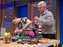 The photo features host, will arnett, standing next to an image of a fan. Did Lego Masters Get Canceled Details On Season 3