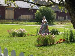 Volunteers In Period Costumn Stroll The Kings Landing Settlement New Brunswick King S Landing Gardens Of The World Volunteer
