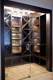 This visually stunning door is made of a single sheet of glass, layered with a wood square grid. Wine Cellar Glass Door Design Home Wine Cellar
