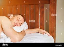 Close-up of young sleeping men in hotel bedroom Stock Photo - Alamy