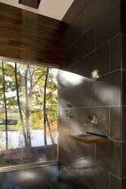 Choosing a mounted sink instead of a full vanity allowed space for a garbage can and small storage stool that can tuck behind the sink, as well as towel hooks just outside the shower door. Incredible Open Shower Ideas For A More Relaxing Bathroom