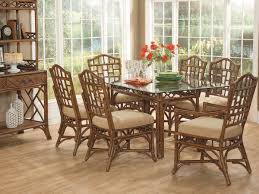 White and black dining room is lit by a white and gold chandelier hung over a chippendale dining table surrounded by white and black french dining chairs placed on a gray rug. Braxton Culler Chippendale Dining Room Set Bxc970076set