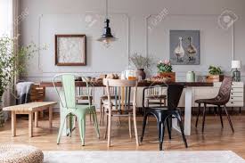 It reminds us of times gone by, of palaces and cottages that time has forgotten, of designs and patterns that were loved many moons ago. Colorful Chairs At Wooden Table In Grey Rustic Dining Room Interior With Posters Flowers And Table Full Of Food Real Photo Stock Photo Picture And Royalty Free Image Image 119191976