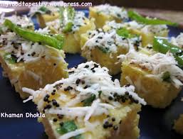 Cheese Dhokla - Dhokla topped with grated cheese, tempered with mustard seeds and green chilies
