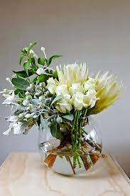 A Gorgeous Bouquet Of White Ice Protea Roses Bouvardia Tetra Nut And Silver Suede Arranged In A Larg Flower Arrangements Vase Arrangements Beautiful Flowers