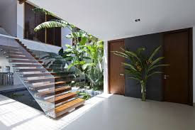 Floating stairs with a clear glass railing lead the way to the home's second level. The Most Beautiful Modern House Entrance Designs