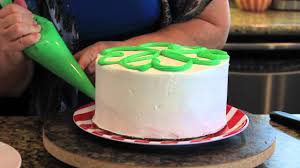 Your best bet is either a book with step by step instructions or a beginners youtube video so you can follow the artists. Decorating A Party Cake In Minutes Youtube