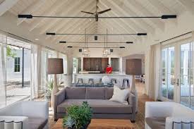 French doors accented with light gray french pleat curtains on brass rods invites a cozy appeal in a transitional living room design. 20 Living Room Ideas With French Doors