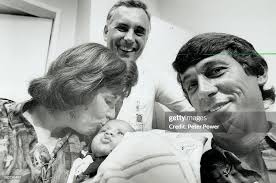 Carol Jilesen kisses her 2-month-old son; Paul; as his successful... News  Photo