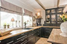Dust particles stand out more on dark cabinet surfaces, which can require more upkeep. Country Style Black Cabinets Wooden Countertop Kitchen