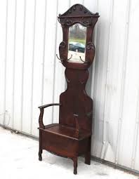 The comfortable seat lets you take a load off while you pry the shoes you've been wearing all day off your feet. 1900 1910 Prob Larkin Mirrored Oak Hat Coat Rack Hall Seat Bench Tree Stand Antique Hall Tree Burled Wood Antiques
