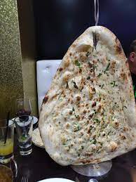 An indian restaurant menu is incomplete without garlic naan. Let S Hang Up The Naan Bread On A Coat Hanger Guests Love That Wewantplates