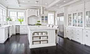 There are lots of contrasting finishes going on in this transitional kitchen—hardwood floors, a natural stone accent wall, dark grey cabinets and a waterfall marble island contribute to the unique rustic design. 45 Luxurious Kitchens With White Cabinets Ultimate Guide Designing Idea