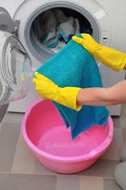 The high temperature of the dryer will cause the fabric to fade over time. Woman Taking Color Clothes From Washing Machine Royalty Free Images Stock Photography Clothes Washing Machine Washing Machine Washing Clothes