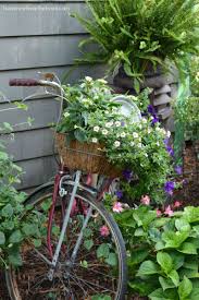 Bicycle with a basket full of flowers. Gardening On Wheels A Bicycle Built For Planting Home Is Where The Boat Is