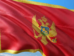 Flag of montenegro the montenegro flag is a red field surrounded by a golden border and in the middle an emblem. National Flag Of Montenegro