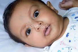 Close Up Face Of Cute Newborn Baby Boy With Black Eyes Posing At Camera One Month Old Sweet Little Infant Toddler Closeup Portrait Indian Ethnicity Front View Child Health Care Background
