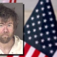 Suspect charged after being accused of assaulting victim with American flag