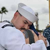 Master-at-Arms 1st Class Laymoun Ferguson lights a candle during a National  Holocaust Remembrance Day ceremony at Commander, Fleet Activities Sasebo.