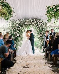Gorgeous Tented Wedding Ceremony Featuring A Green And White Floral Arch And Hanging In 2020 Wedding Ceremony Backdrop Outside Wedding Ceremonies Wedding Ceremony Arch