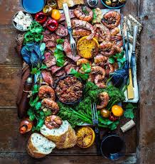 Woodfire Grilled Surf Turf Platter With Prime Grade Tenderloin Chilean Prawn And A Garden Of Fresh Greens And Herbs Gorgeous Food Meat Platter Food Platters