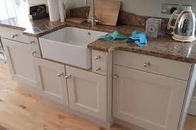 Simply dip the tip of a paintbrush in a color lighter than the cabinets and dab the excess onto a cloth until the brush is almost dry, then lightly graze the surface of the detail trim, corners, and seams. How To Paint Kitchen Cabinets A Guide From Start To Finish