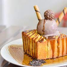 A Thick Brick Of Buttery Shibuya Toast Crisp Buttery And Hollowed Out To Be Filled With Molten Thai Tea Lava Served On A Just Desserts Desserts Food