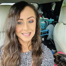 Feeding a raccoon and her babies