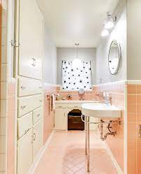 Add a new vintage looking black and white tile floor, a new taller vanity, and a bamboo shade. 16 Pink Bathrooms That Prove This Color Works In Any Room Tile Bathroom Pink Tile Bathroom Vintage Bathroom Tile