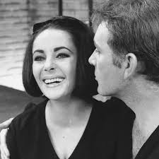 Standing alongside Richard Burton, Elizabeth celebrates her 32nd birthday  with a little cake 🎂