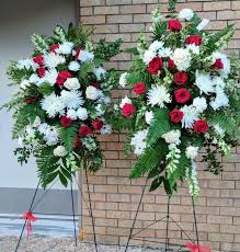 Tied sheaf of funeral flowers in classic bright red and white tones. Whole Red And White Two Standing One Casket Spray Flora Funeral Flowers Are Happy