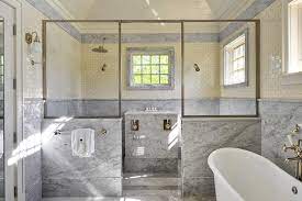 Choose a tile color with high variation to create a mesmerizing underwater feel. Glass And Subway Tile Shower Pony Wall Design Ideas