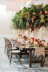 Tropical Garden Wedding Centerpiece With Palm Leaves Fronds Wood Farm Tables Crossbac Garden Wedding Centerpieces Tropical Wedding White Wedding Ceremony