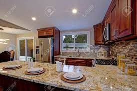 Brown cabinets were extremely popular in traditional kitchen designs throughout the 1900's. Brown Kitchen Design With Mahogany Kitchen Cabinets Breakfast Stock Photo Picture And Royalty Free Image Image 95634470