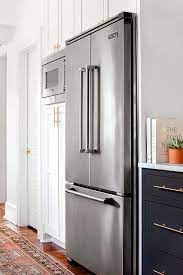The adjacent counter ends cleanly at the panel. Pantry Cabinets Framing Viking Fridge Next To Microwave Transitional Kitchen