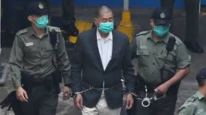 Jimmy lai, who is a uk citizen, is handcuffed and and escorted to a van. T Gnxqrrgb7b2m