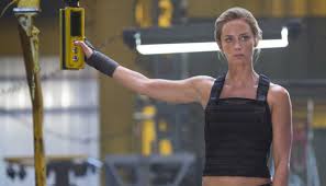 Emily blunt, star of sicario, sitting on a bed with a guy while in a bra, showing cleavage as they snap some pictures with a polaroid camera and kiss. New Clip From Sicario Featuring Emily Blunt 411mania