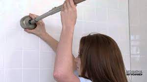 Wedge the tension rod into place, making sure to hold one end over the mark on one side of the shower while compressing the rod onto the other mark on the opposite side. The Gripper Easy Install Adjustable Curved Shower Rod At Bed Bath Beyond Youtube