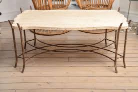 An elegant limestone top sits balanced on perfectly fitted groves that open into the wooden legs of this jorge zalszupin coffee table. Faux Bois Iron Base Limestone Top Coffee Table With Scalloped Edge At 1stdibs