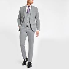 The pants in a modern fit suit are straight legged, but with a more extra fabric than a slim fit pant. Grey Stretch Skinny Fit Suit Trousers River Island