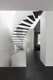 A Notable Curved Stairwell With Missing Risers Is Visible From The Dining Table Space Architecture Interior Stairs Brick Architecture