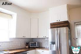 You could use bridging cabinets above your standard wall units, which should be short enough to fit in the space. How I Closed The Space Above My Cabinets A Butterfly House